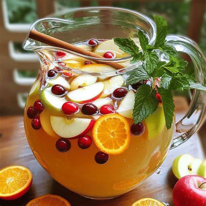 Apple cider sangria with cranberries, orange and apple slices.
