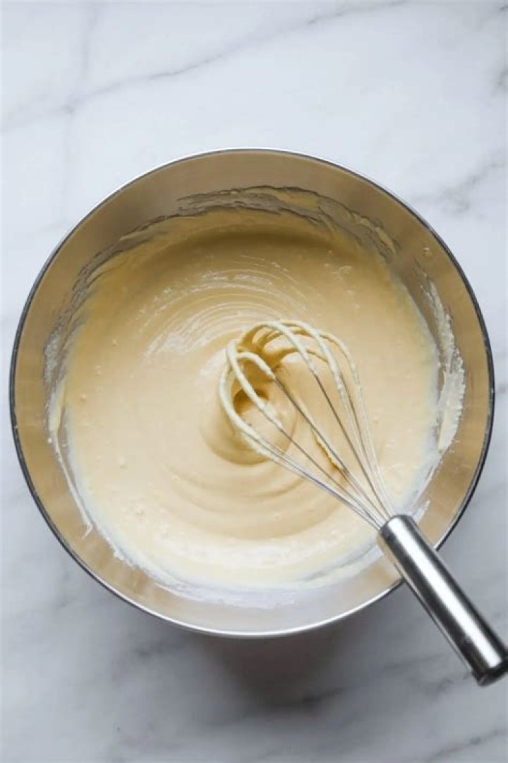 Cheesecake batter in a metal bowl.